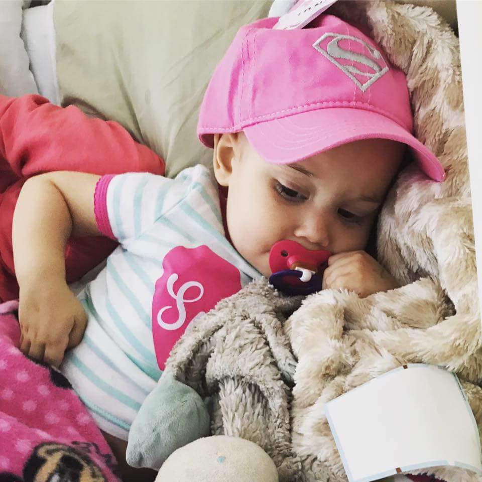 Child with cancer sleeping peacefully in a hospital bed