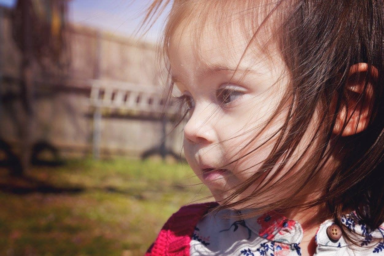 Beautiful, sweet photo of Sophie Skiles at age 2, her hair blowing in the wind
