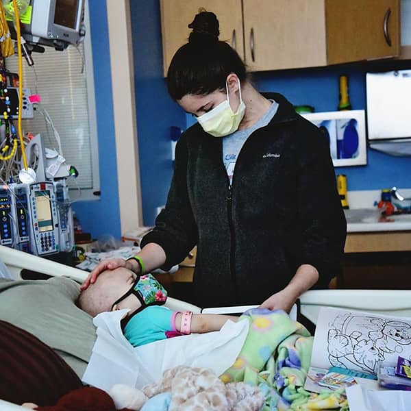 Shelby Skiles beside the bed of her daughter Sophie