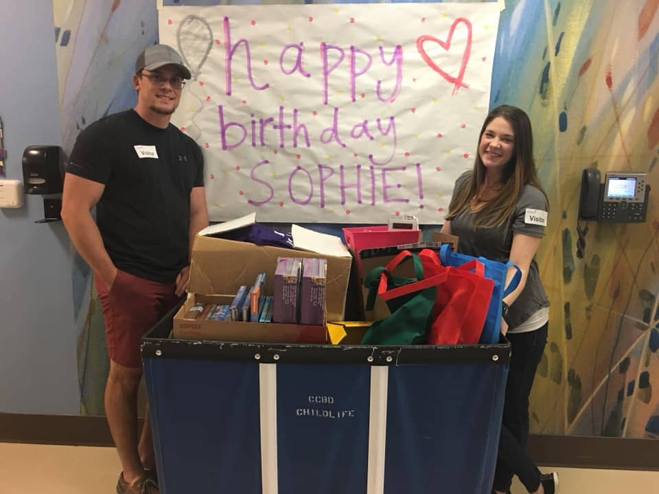 Jonathan and Shelby Skiles at the hospital delivering bundles of gifts to families whose children are battling cancer